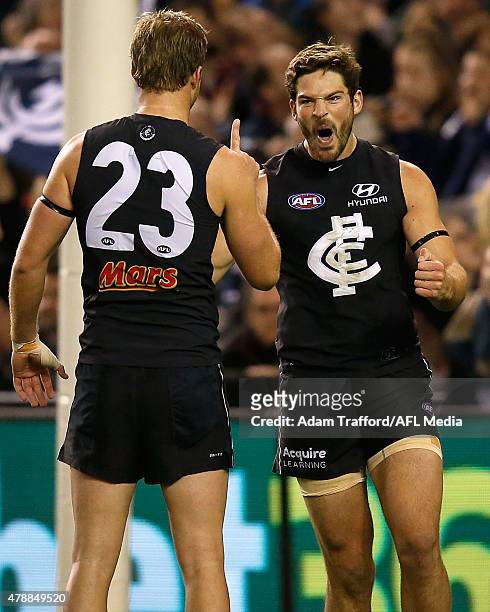 Levi Casboult of the Blues celebrates a goal with Lachie Henderson during the 2015 AFL round thirteen match between the Carlton Blues and the Gold...