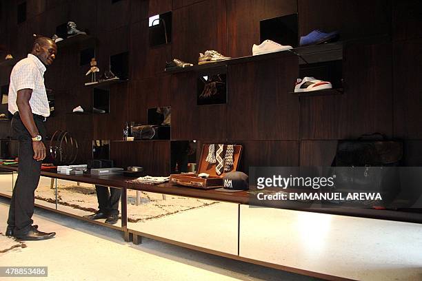 Man looks at accessories in Alara, a new retail concept store, on May 19, 2015 on Victoria Island, Lagos. Founded by Reni Folawiyo, the store offers...