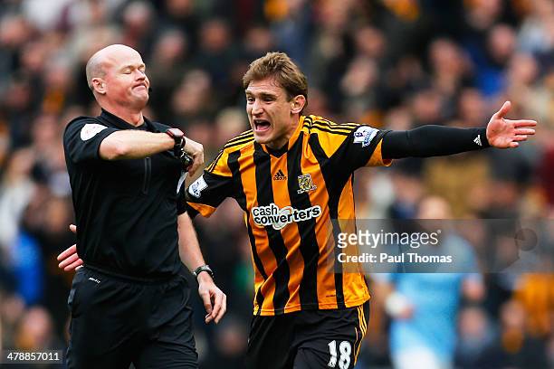Nikica Jelavic of Hull City reacts as Referee Lee Mason shows the red card to Vincent Kompany of Manchester City during the Barclays Premier league...