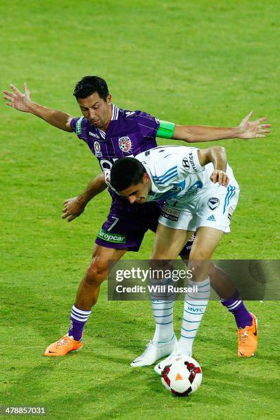 Tom Rogic of the Victory and Jacob Burns of the Glory challenge for the ball during the round 23 A-League match between Perth Glory and Melbourne...