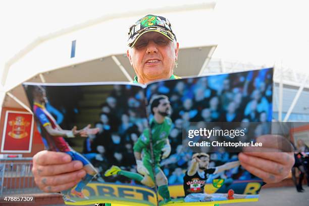 Norwich City supporter reads the match day programme during the Barclays Premier League match between Southampton and Norwich City at St Mary's...