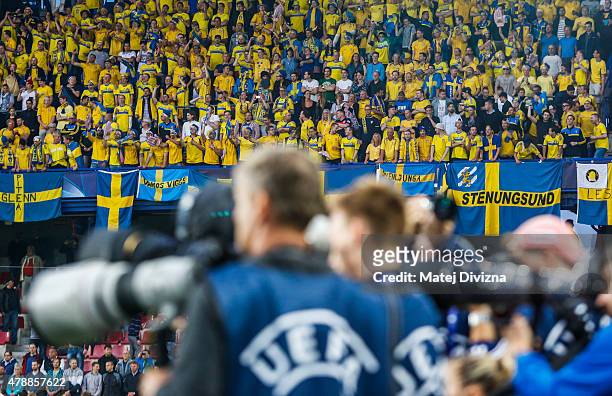 Fans of Sweden are seen behind photographers before UEFA U21 European Championship semi final match between Denmark and Sweden at Generali Arena on...