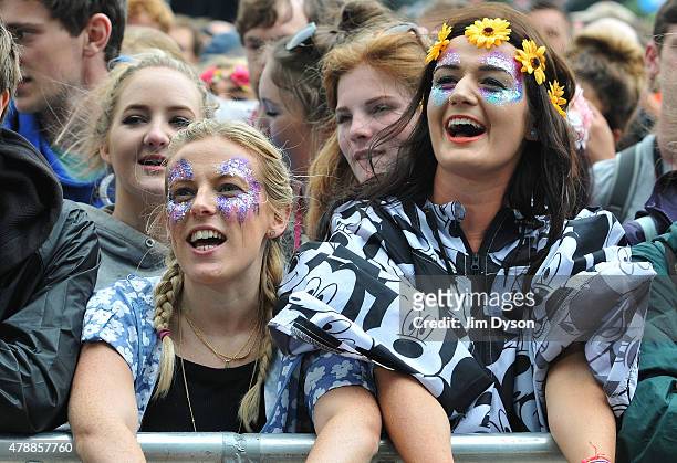 Girls in glitter make up watch Hozier perform on the Pyramid stage during the third day of the Glastonbury Festival at Worthy Farm, Pilton on June...