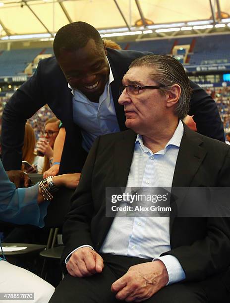 Gerald Asamoah, a former player, talks to former manager Rudi Assauer during the general assembly of FC Schalke 04 at Veltins-Arena on June 28, 2015...