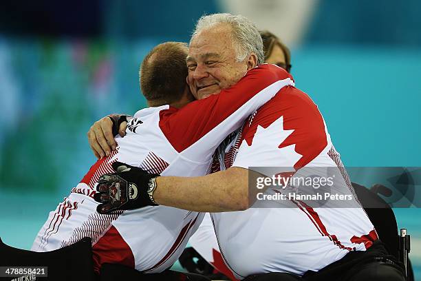 Dennis Thiessen celebrates with Jim Armstrong of Canada after winning the gold medal match between Russia and Canada on day eight of Sochi 2014...