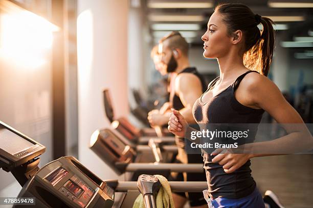 people running on a treadmill in health club. - gym bildbanksfoton och bilder