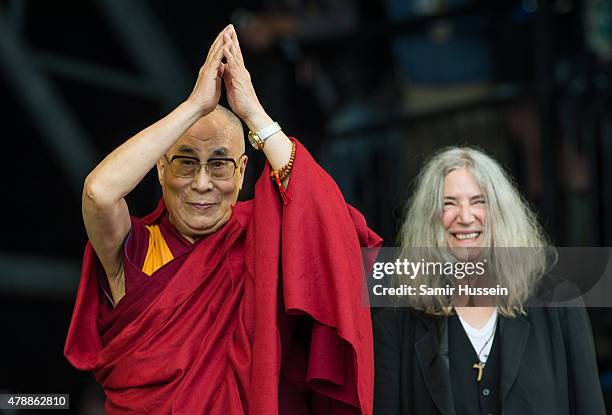 His Holiness The Dalai Lama appears on stage with Patti Smith as she performs at the Glastonbury Festival at Worthy Farm, Pilton on June 28, 2015 in...