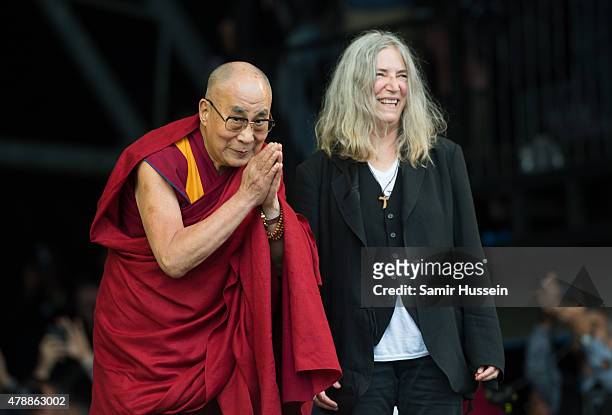 His Holiness The Dalai Lama appears on stage with Patti Smith as she performs at the Glastonbury Festival at Worthy Farm, Pilton on June 28, 2015 in...