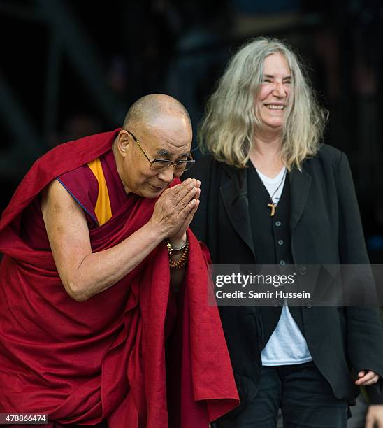 His Holiness The Dalai Lama appears on stage with Patti Smith as she performs at the Glastonbury Festival at Worthy Farm, Pilton on June 28, 2015 in...