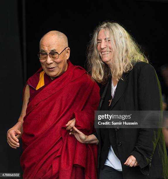 His Holiness The Dalai Lama appears on stage with Patti Smith as she performs at the Glastonbury Festival at Worthy Farm, Pilton on June 28, 2015 in...