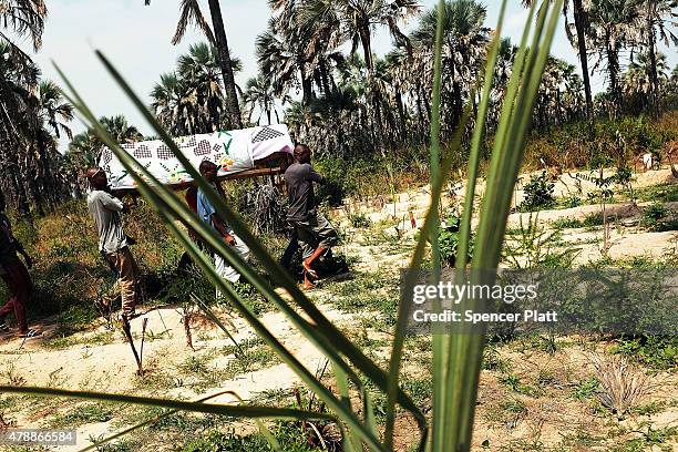 The coffin of a man killed in a confrontation the previous evening is viewed at his Muslim funeral on June 28, 2015 in Bujumbura, Burundi. It is...