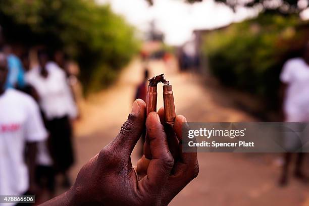 Spent bullet casings are held in a street where a man who was killed by police the previous evening on June 28, 2015 in Bujumbura, Burundi. Patrick...