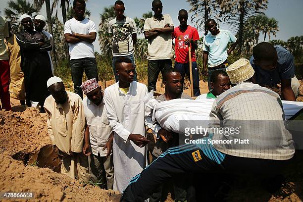 The body of a man killed in a confrontation the previous evening is buried at his muslim funeral on June 28, 2015 in Bujumbura, Burundi. It is...