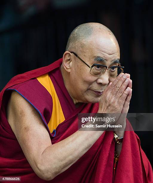 His Holiness The Dalai Lama appears on stage with Patti Smith as she performs at the Glastonbury Festival at Worthy Farm, Pilton on June 28, 2015 in...