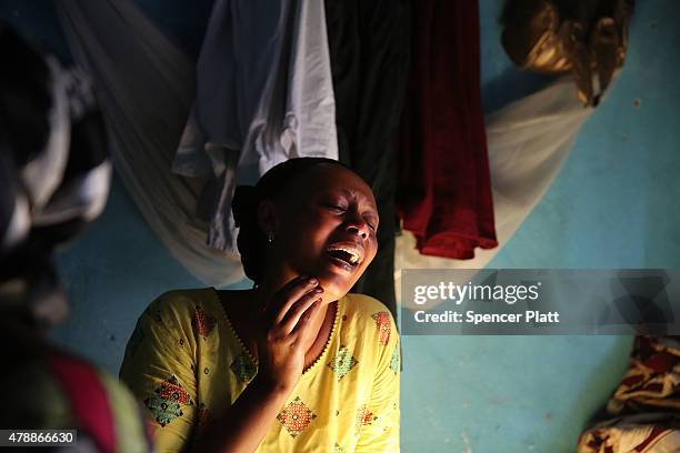 Relative of a man who was killed by police the previous evening grieves on June 28, 2015 in Bujumbura, Burundi. Patrick Ndikumana was shot and killed...