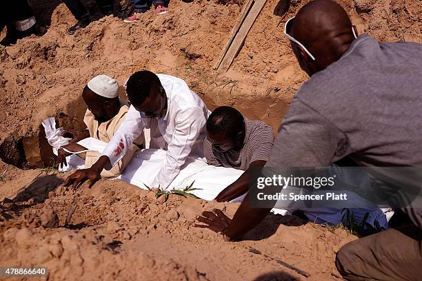 The body of a man killed in a confrontation the previous evening is buried at his muslim funeral on June 28, 2015 in Bujumbura, Burundi. It is...