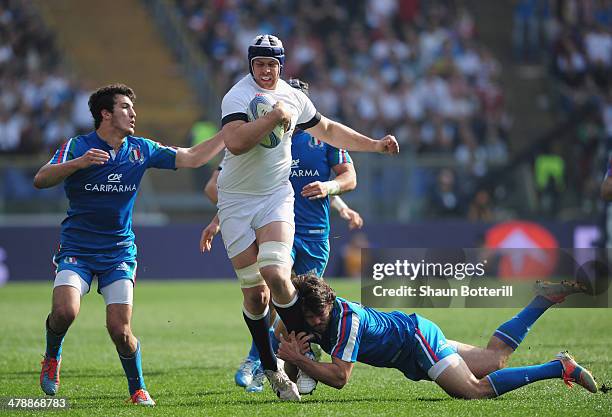 Dave Attwood of England is tackled by Luke McLean and Leonardo Sarto of Italy during the RBS Six Nations match between Italy and England at Stadio...