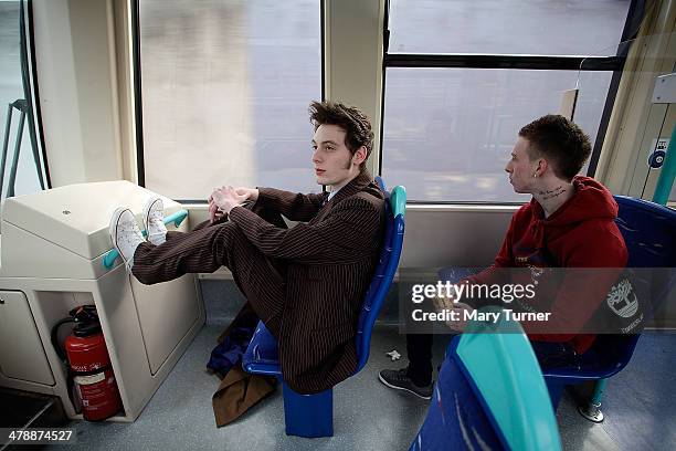 Ben Randall, a lookalike of the 10th Doctor Who, sits on the Docklands Light Railway on his way to the London Super Comic Convention on March 15,...