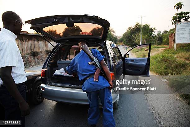 Police check cars for weapons on the outskirts of an opposition neighborhood on June 28, 2015 in Bujumbura, Burundi. The head of Burundi's...