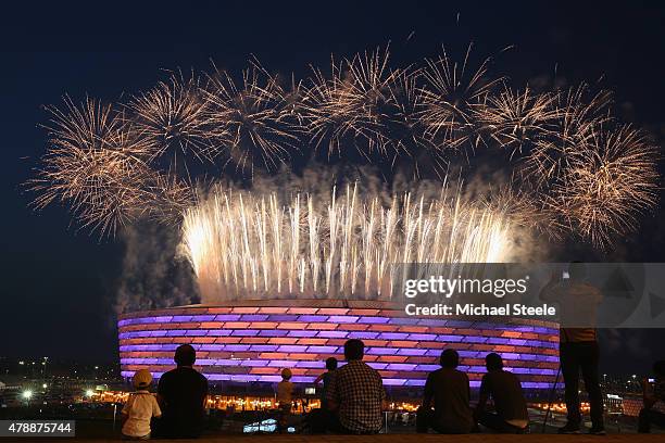 Fireworks explode as locals look on outside the Olympic Stadium during the Closing Ceremony for the Baku 2015 European Games at xxx on June 28, 2015...