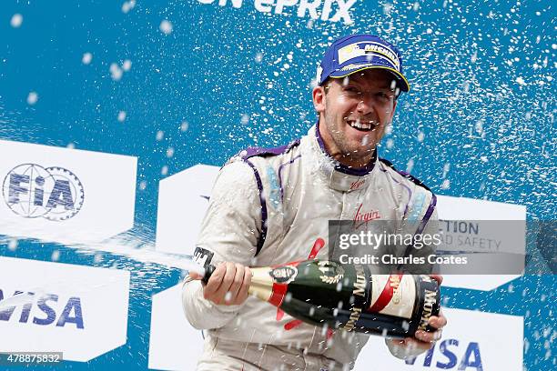 Sam Bird of Great Britain celebrates on the podium after winning the Formula E race at Battersea Park Track on June 28, 2015 in London, England.