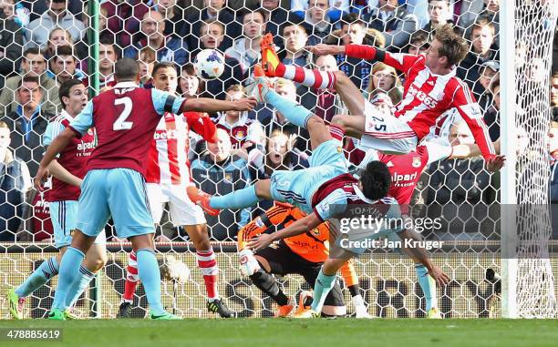 Peter Crouch of Stoke City's shot deflects in to the goal off of Peter Odemwingie of Stoke City for their first as James Tomkins of West Ham United...