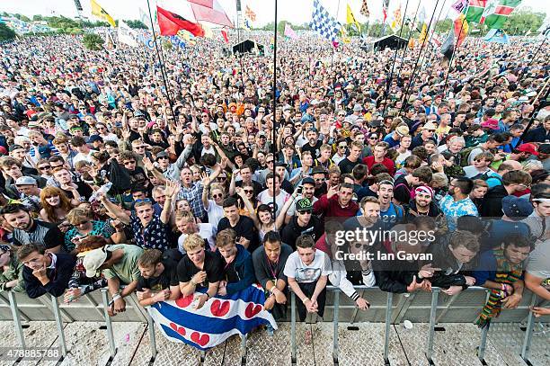 The crowd gathers before Paul Weller performs on the Pyramid Stage at the Glastonbury Festival at Worthy Farm, Pilton on June 28, 2015 in...