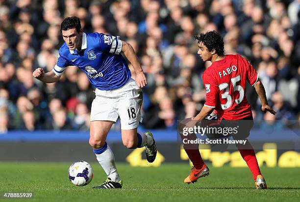 Gareth Barry of Everton competes with Fabio Da Silva of Cardiff City during the Barclays Premier League match between Everton and Cardiff City at...