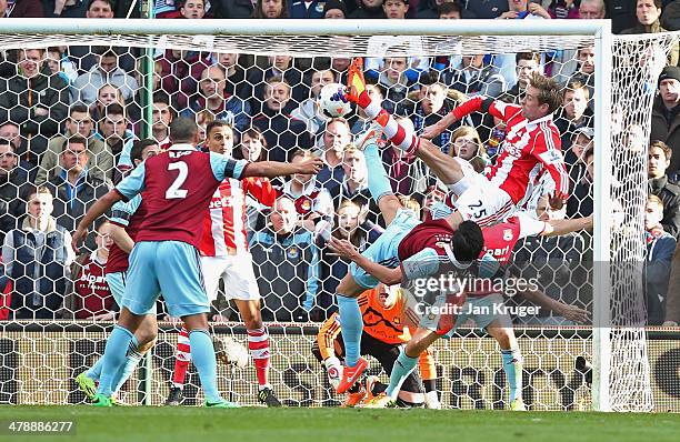 Peter Crouch of Stoke City's shot deflects in to the goal off of Peter Odemwingie of Stoke City for their first as James Tomkins of West Ham United...