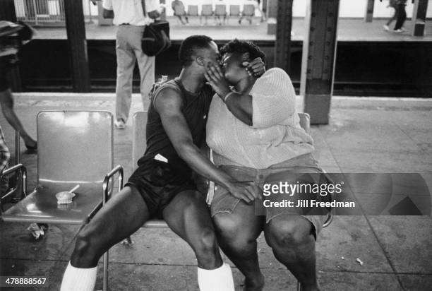 Young couple kissing on a subway platform in New York City, 1985.