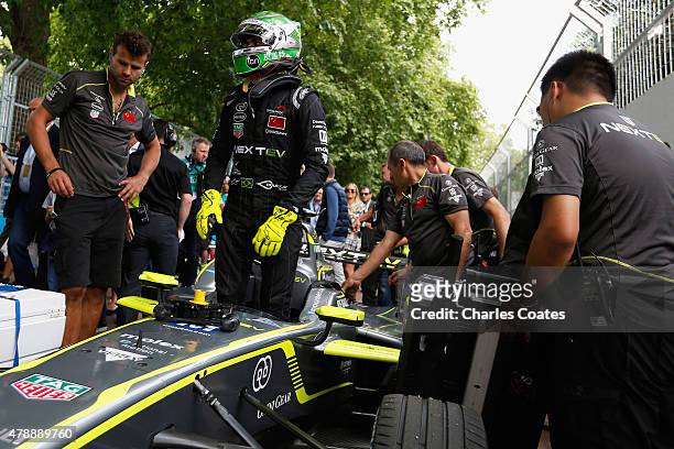 Nelson Piquet Jnr of Brazil steps from his team NEXTEV TCR Formula E car on the grid at Battersea Park Track on June 28, 2015 in London, England.