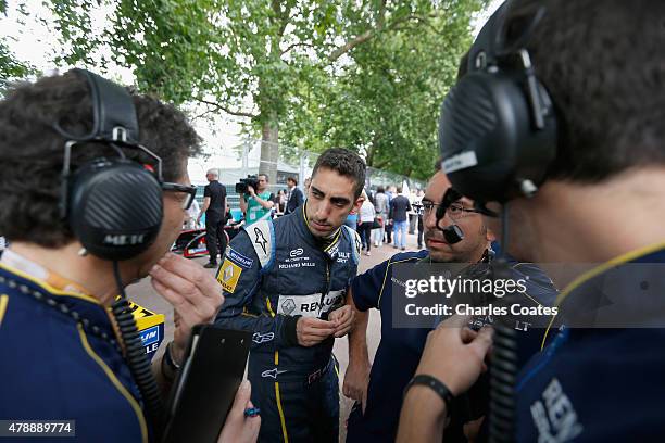 Sebastien Buemi of Switzerland talks with hus engineers on the grid at Battersea Park Track on June 28, 2015 in London, England.