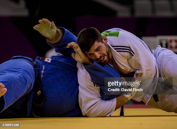 Cyrille Marat of France holds Adam Okruashvili of Georgia for an ippon to seal the gold medal for the French Men's team during day sixteen of the...