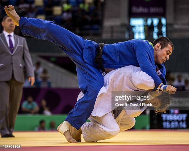 Loic Pietri of France throws Avtandili Tchrikishvili of Georgia to win the contest and secure France four wins to one and the team gold medal during...