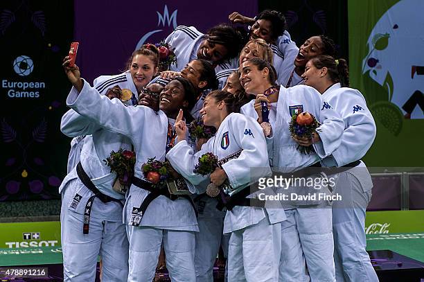 Members of the gold medal winning French Women's team and the Italian bronze medallists pose for a 'Selfie' after the Team Medal Ceremony during day...