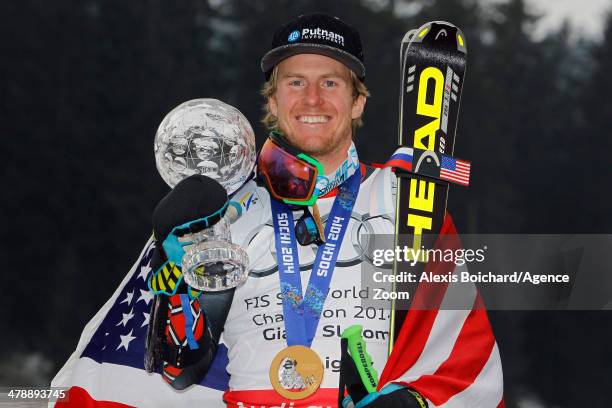 Olympic gold medallist Ted Ligety of the USA with the overall giant slalom World Cup globe on March 15, 2014 in Lenzerheide, Switzerland.