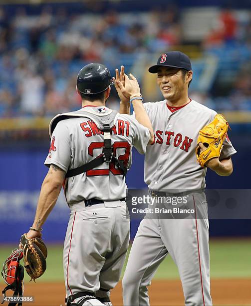 Pitcher Koji Uehara of the Boston Red Sox and catcher Blake Swihart celebrate their 5-2 win over the Tampa Bay Rays at the end of a game on June 28,...