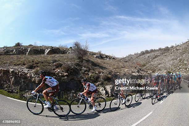 Race leader and yellow jersey Carlos Gomez Betancur of Colombia and AG2R La Mondiale is protected by team mates lead by Sebastien Minard of France up...