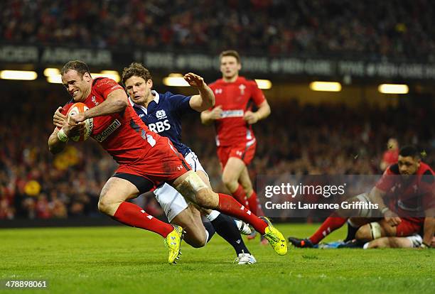 Jamie Roberts of Wlaes scores a try under pressure from Ross Ford of Scotland during the RBS Six Nations match between Wales and Scotland at...