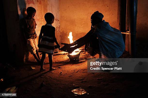 Homeless family cooks their dinner on an open fire in the street on June 28, 2015 in Bujumbura, Burundi. The head of BurundiÕs influential rights...