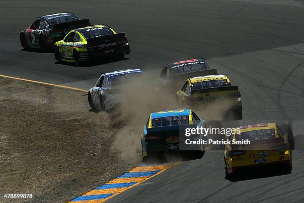 Martin Truex Jr., driver of the Furniture Row/Visser Precision Chevrolet, crashes into the wall during the NASCAR Sprint Cup Series Toyota/Save Mart...