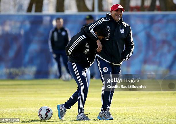 Ramon Diaz, coach of Paraguay and his son Emiliano Diaz, coach assistant joke during a training session at ENAP training camp as part of 2015 Copa...
