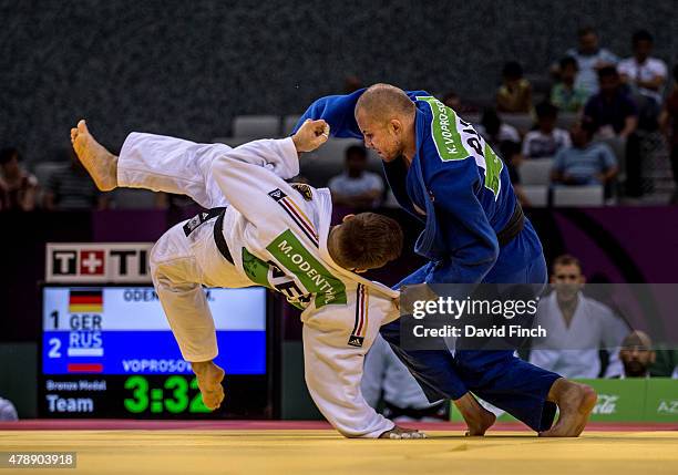 Marc Odenthal of Germany is thrown for an ippon by Kirill Voprosov of Russian with a foot sweep with the Russians winning the bronze medal by three...