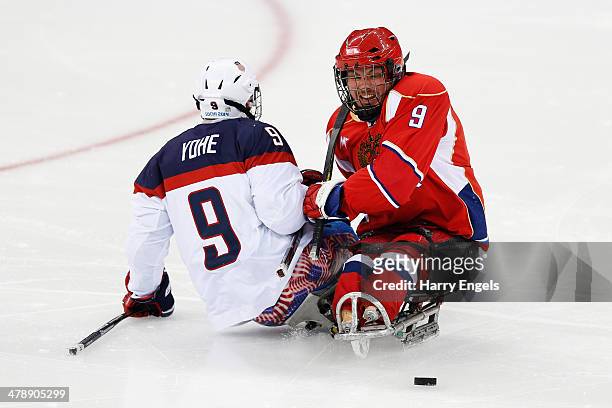 Konstantin Shikhov of Russia collides with Andy Yohe of USA during the Ice Sledge Hockey Gold Medal match between Russia and USA at the Shayba Arena...
