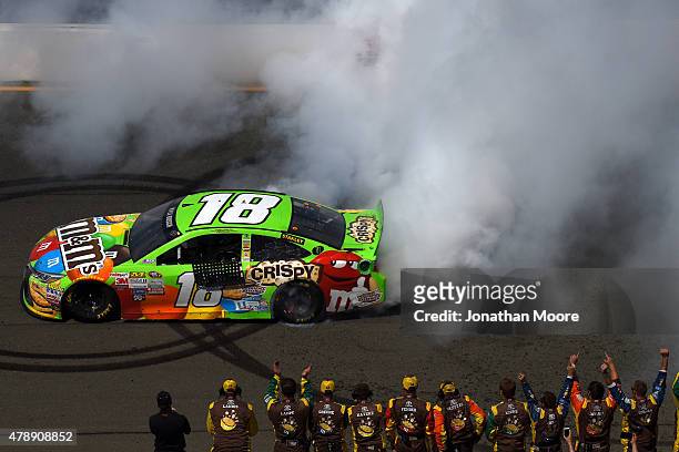 Kyle Busch, driver of the M&M's Crispy Toyota, celebrates with a burnout after winning the NASCAR Sprint Cup Series Toyota/Save Mart 350 at Sonoma...