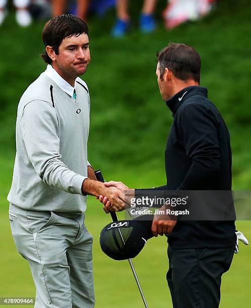 Bubba Watson shakes hands with Paul Casey of England after defeating him in a playoff to win the final round of the Travelers Championship at TPC...