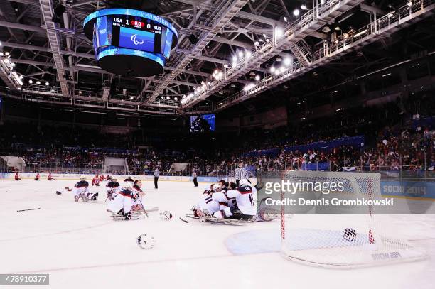 United States players celebrate after winning gold in the ice sledge hockey gold medal game between the Russian Federation and the United States of...