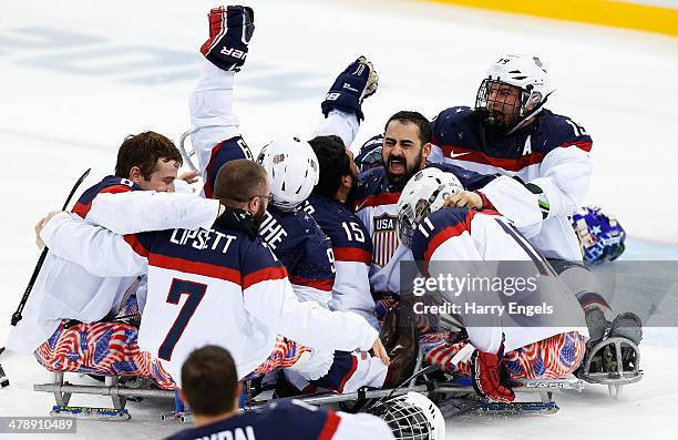 The USA team celebrate winning the Ice Sledge Hockey Gold Medal match between Russia and USA at the Shayba Arena during day eight of the 2014...