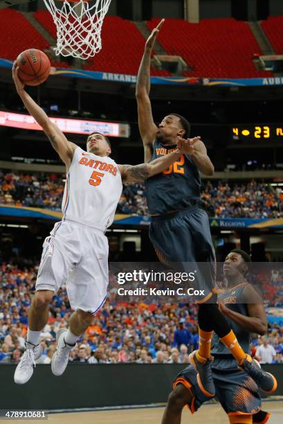 Scottie Wilbekin of the Florida Gators goes up for a shot against Jordan McRae of the Tennessee Volunteers during the semifinals of the SEC Men's...