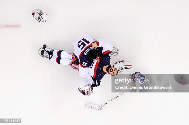 Steve Cash of the United States celebrates winning the gold medal with Nikko Landeros after the Ice Sledge Hockey Gold Medal game between the United...